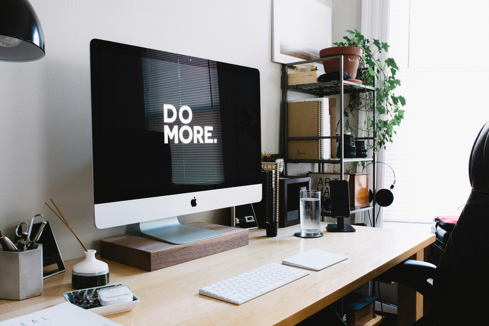 Professional workspace with 'DO MORE' message